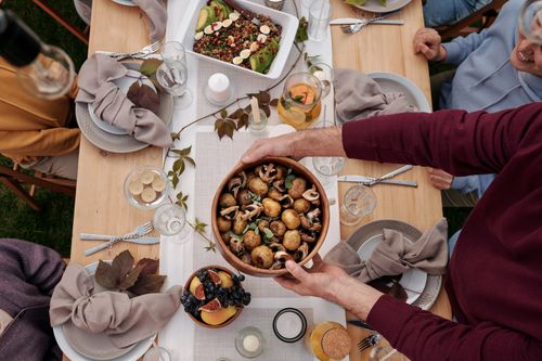 Free Overhead view of a festive family dinner with a seasonal meal spread on a wooden table. Stock Photo