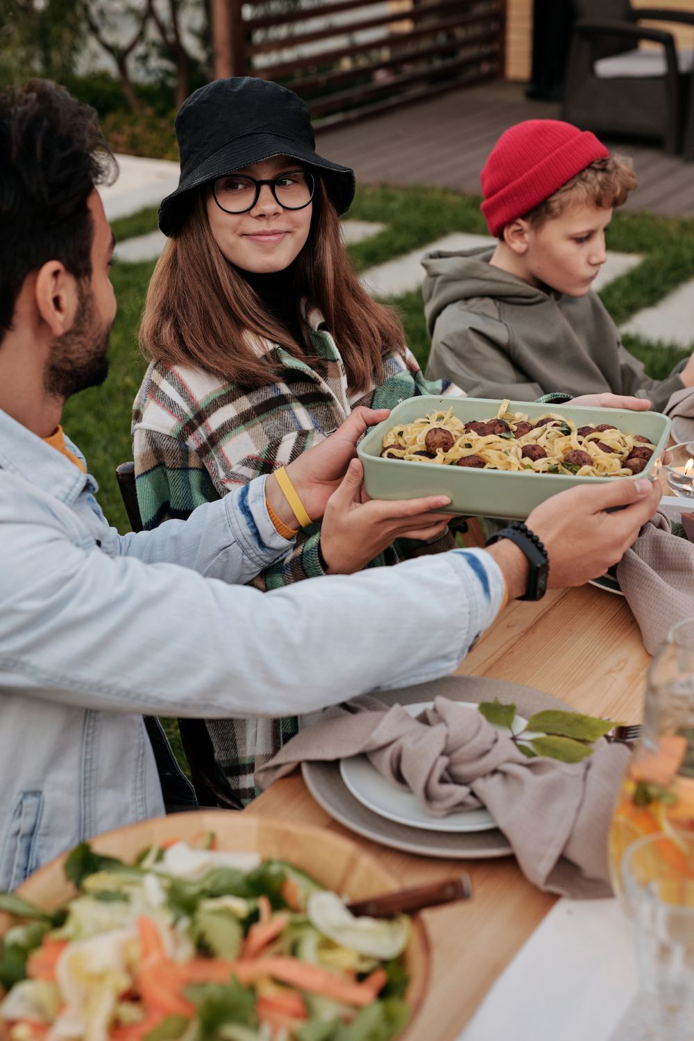 People sharing a meal together at a long table