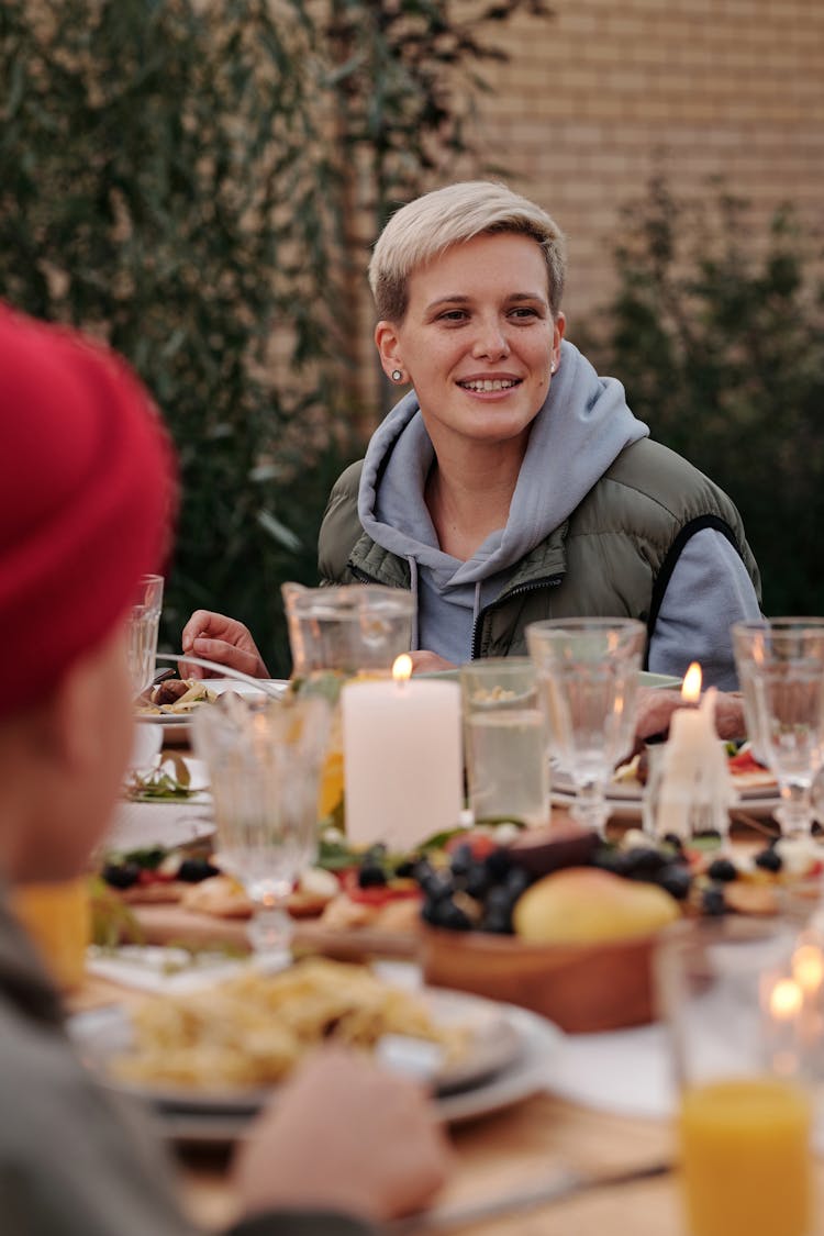 Cheerful Hipster Woman Enjoying Delicious Dinner Together With Friends