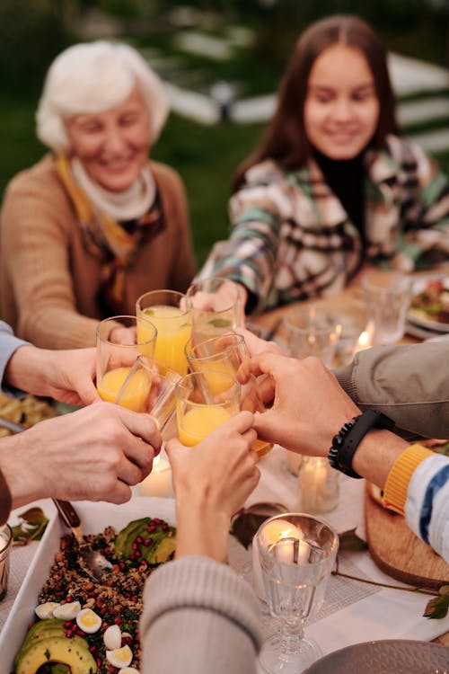 Free Crop people clinking with glasses at dinner Stock Photo