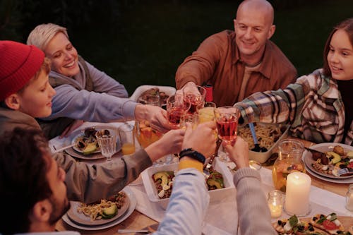Cheerful family toasting during evening dinner