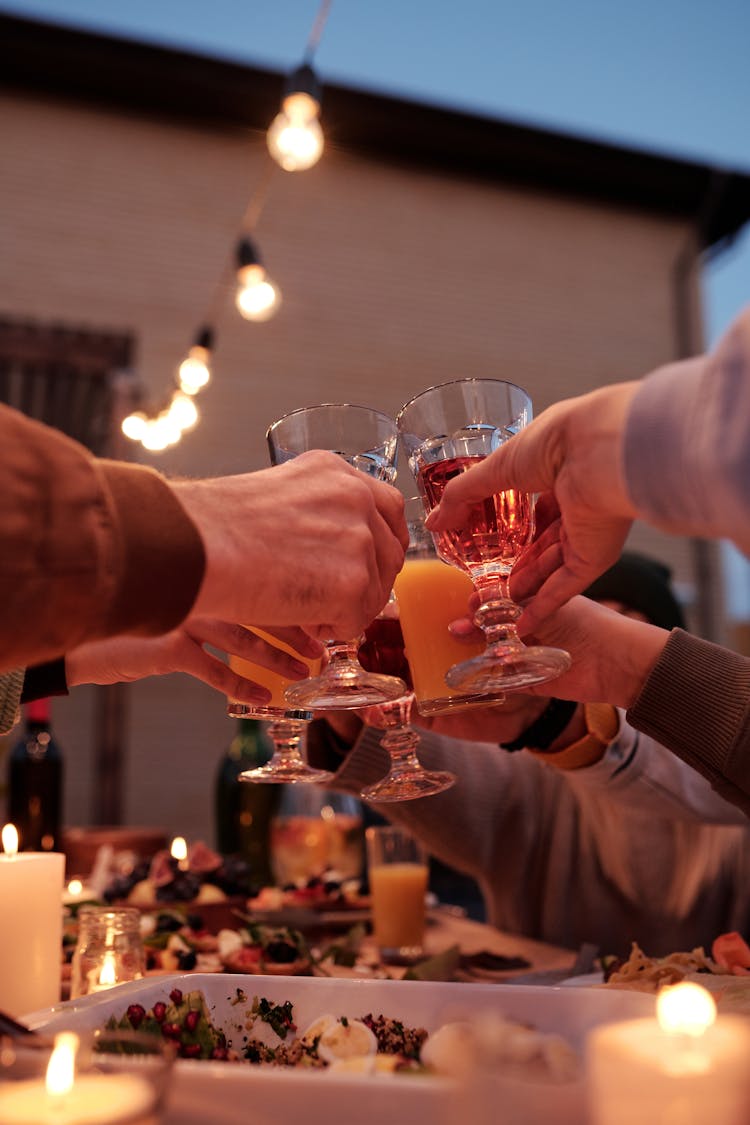 Faceless People Cheering At Dinner In Glowing Backyard