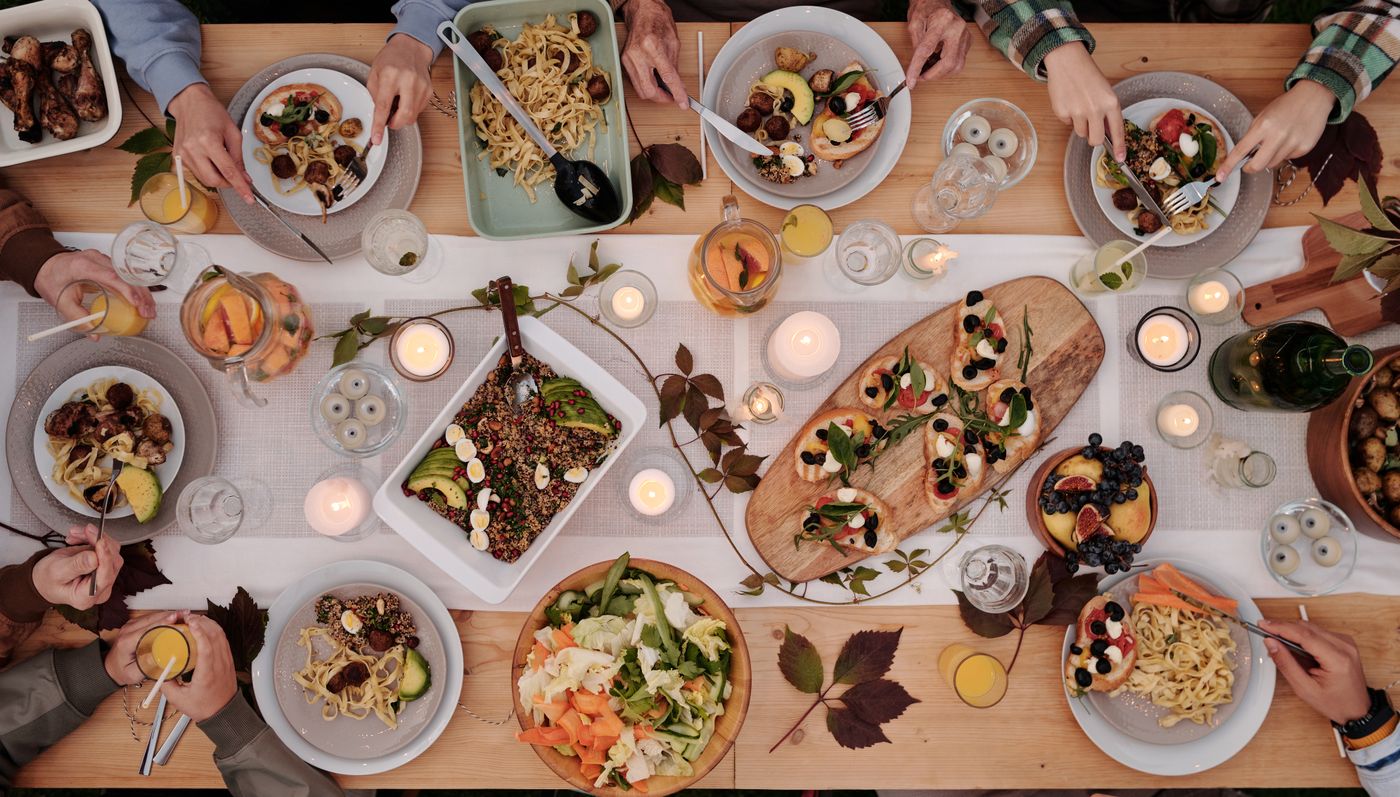Long table set with shared dishes seen from above
