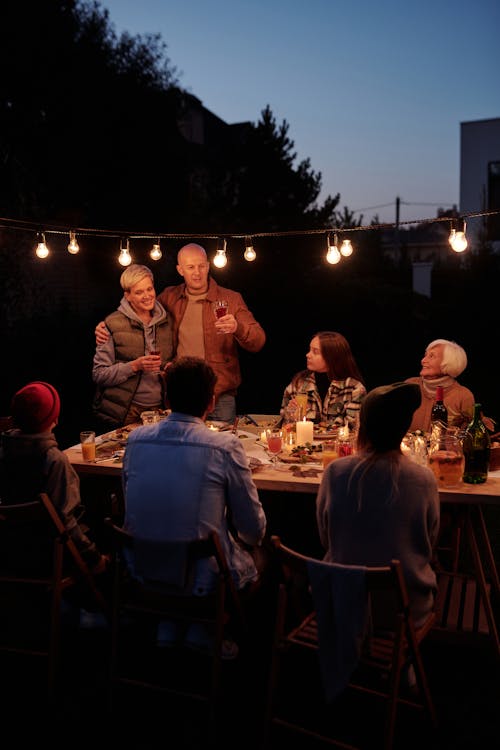 People Sitting on Chair Near Table during Night Time