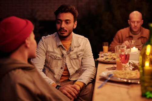 Free People chatting during evening dinner in backyard Stock Photo