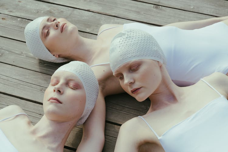 A Close-Up Shot Of Women In Swimsuits Lying Down On The Floor