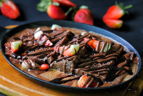 Brownies with Sliced Strawberries and Chocolate Syrup
