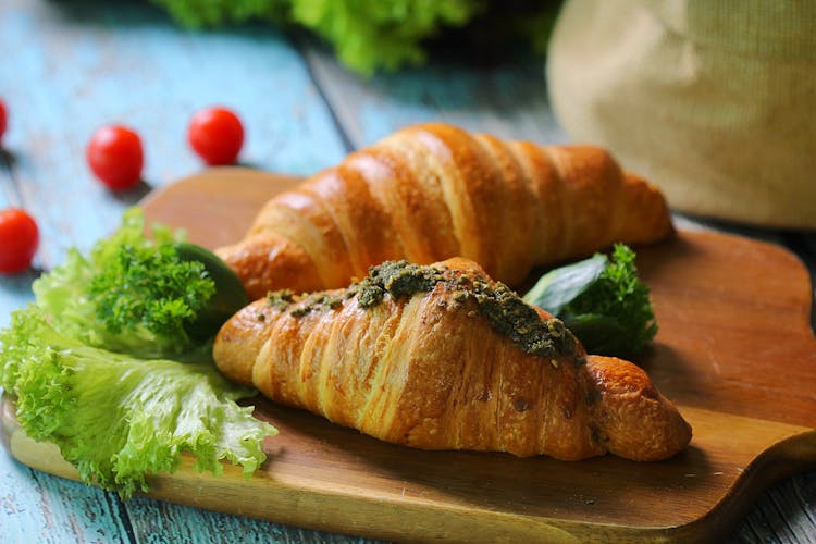 Two Croissants On A Wooden Serving Board