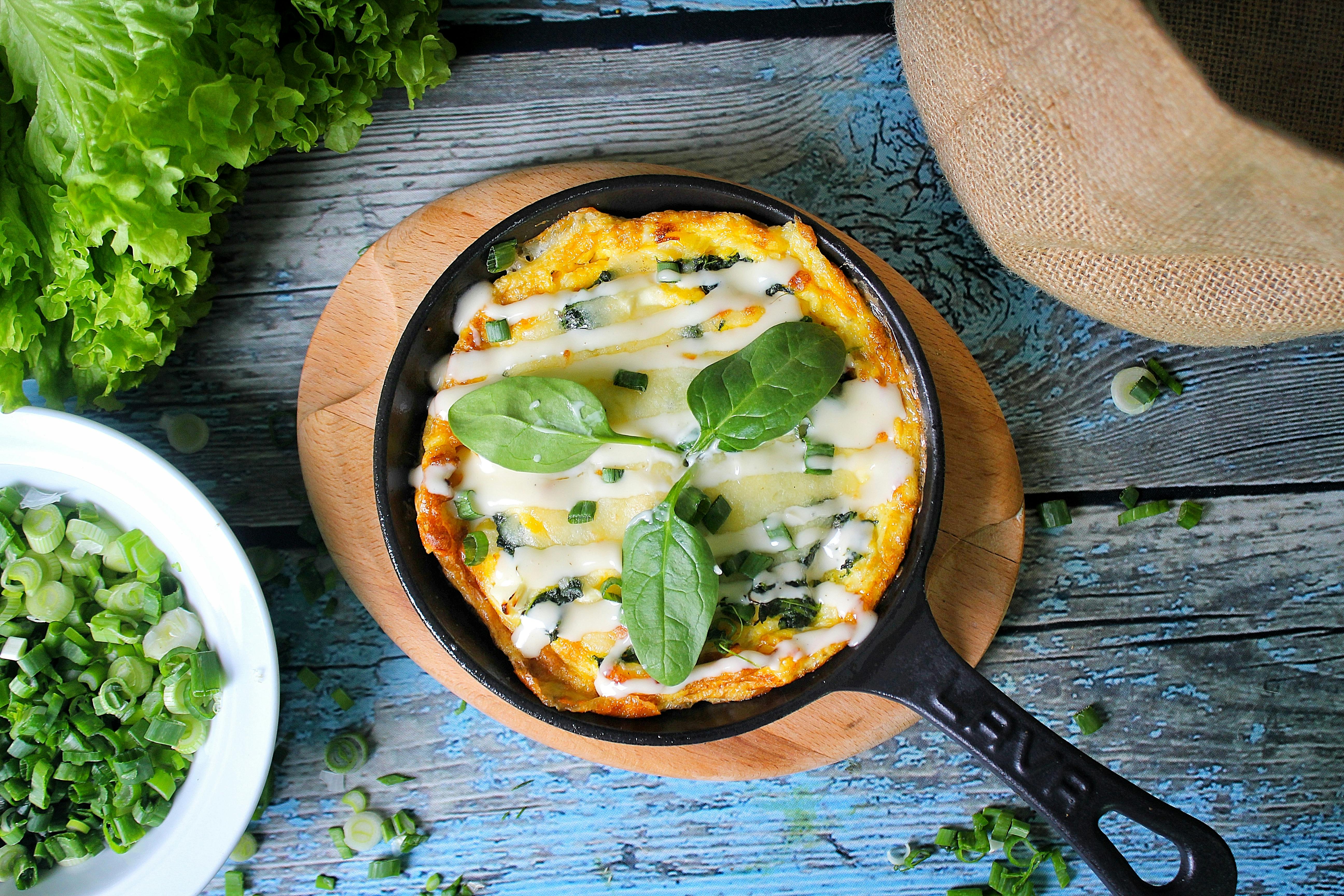 Free Scrambled Eggs with Green Onions on Black Skillet Pan Stock Photo
