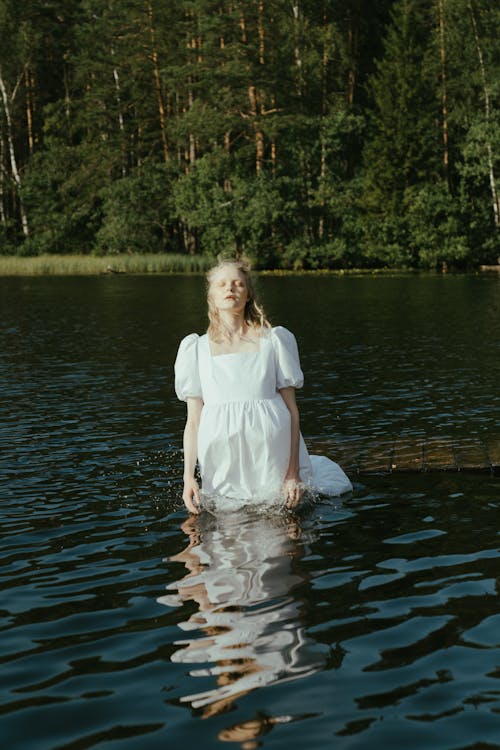 2 Women in White Dress Standing on Water · Free Stock Photo