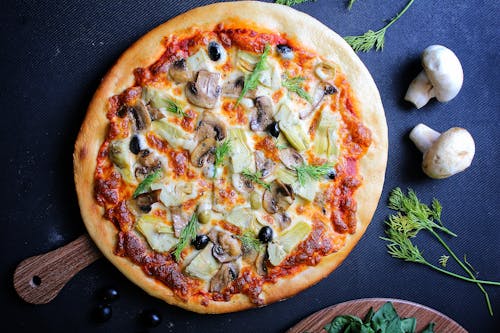 Pizza With Green Leaves and Cheese