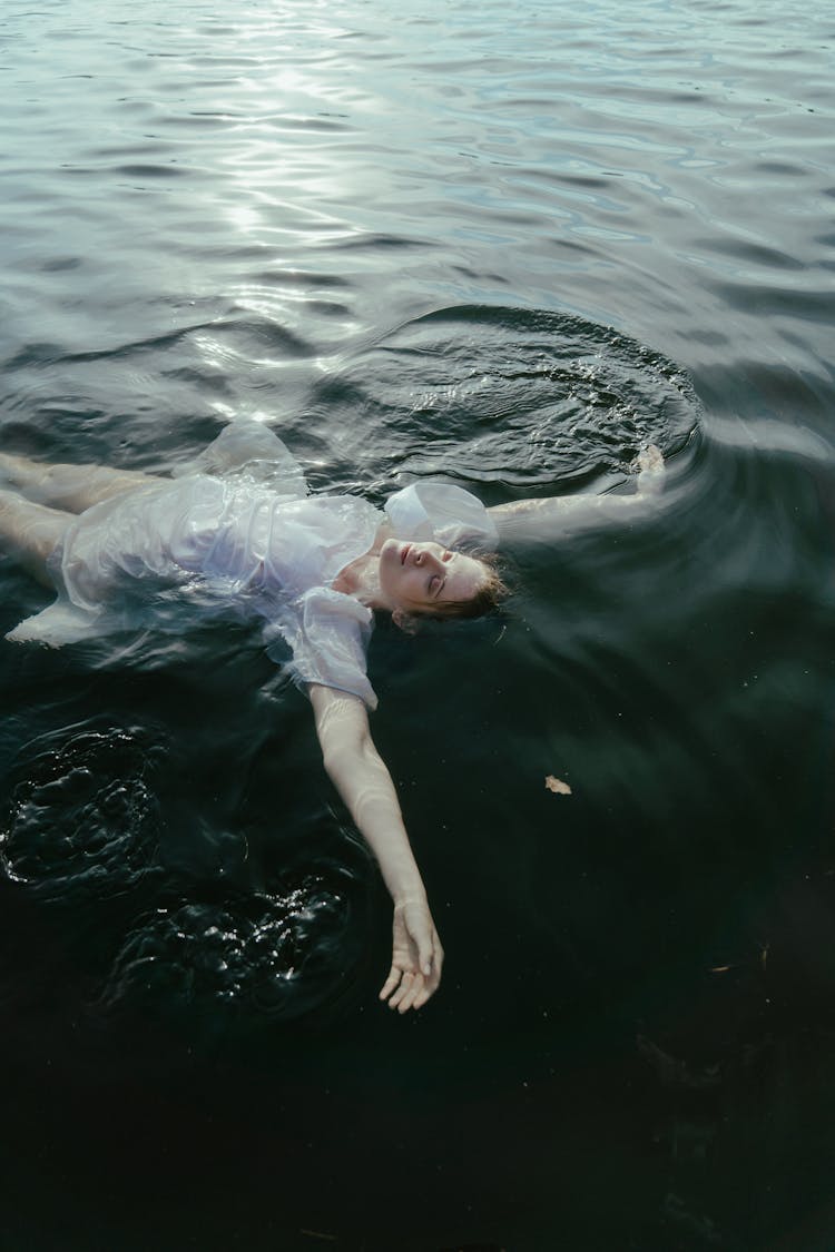 Photo Of A Woman Floating On Water