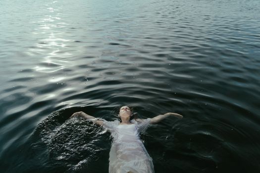 一个女人静静地漂浮在平静的水面上，散发着宁静与自由
