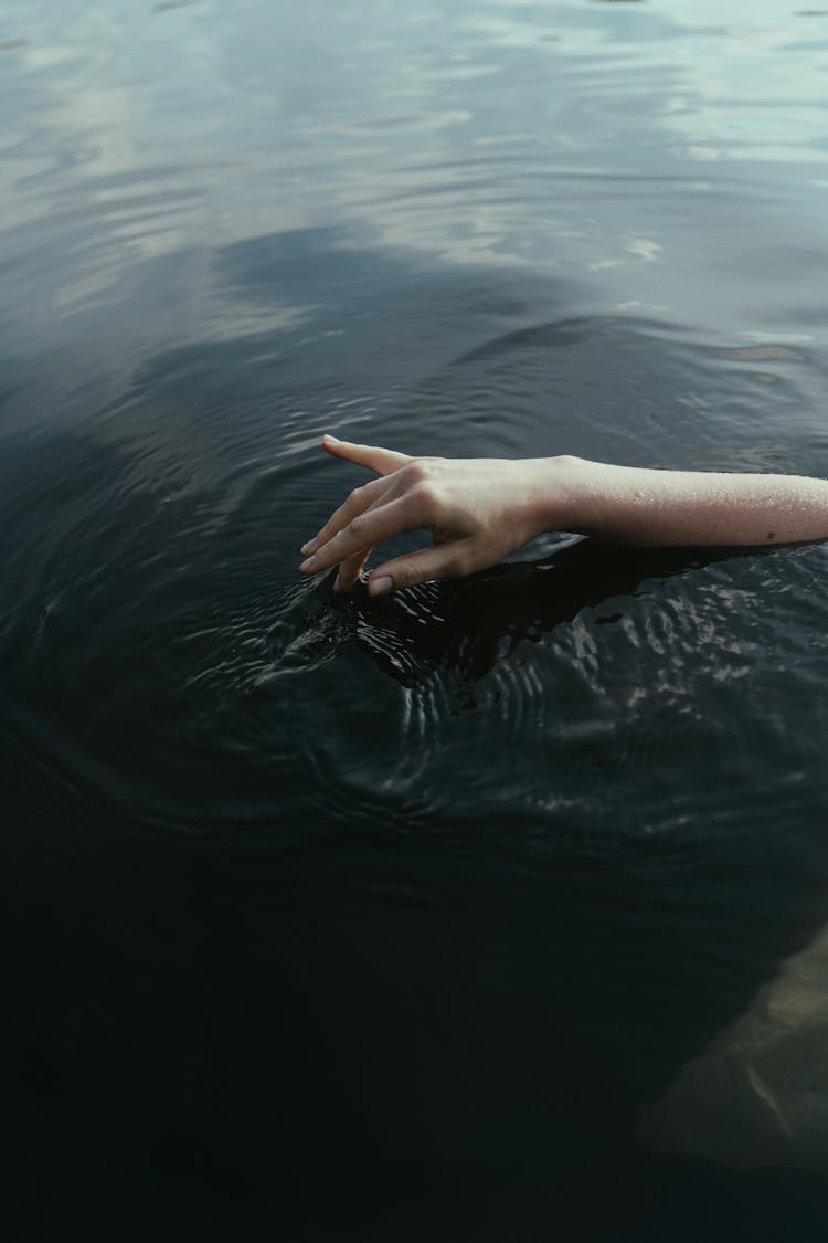 Person Touching A Water Surface