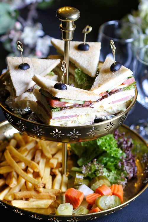 Free Gourmet sandwiches and fries elegantly displayed on a two-tiered serving tray. Stock Photo