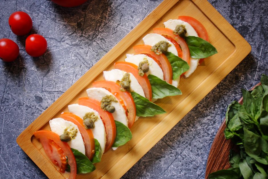 Colorful Caprese skewers with fresh mozzarella and cherry tomatoes on a serving platter - mozzarella tomato basil appetizer Colorful Caprese skewers with fresh mozzarella and cherry tomatoes on a serving platter - mozzarella tomato basil appetizer