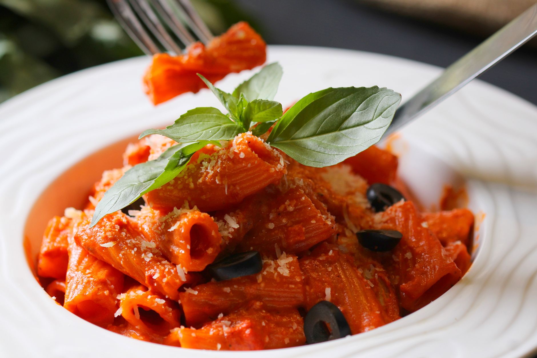 close up of baked rigatoni in creamy cheese sauce