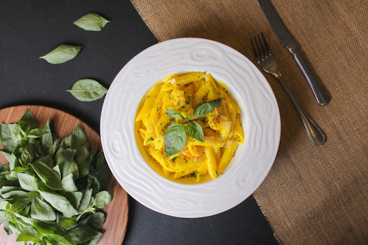 Yellow Pasta On White Ceramic Plate