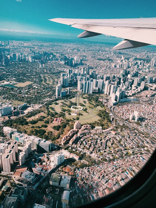 Aerial View of City Buildings from Airplane Window