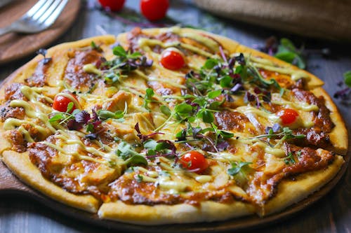 Pizza With Green Leaves and Cheese