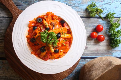 Free Top view of Italian pasta with olives and tomatoes on a rustic wooden board. Stock Photo