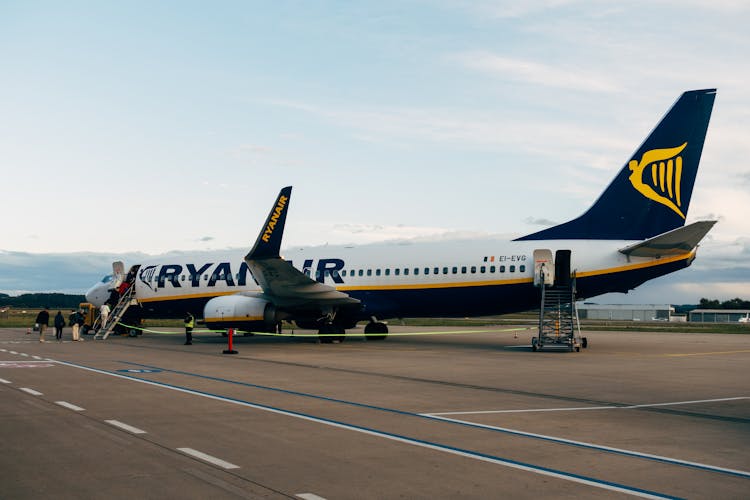 People Boarding An Airplane 