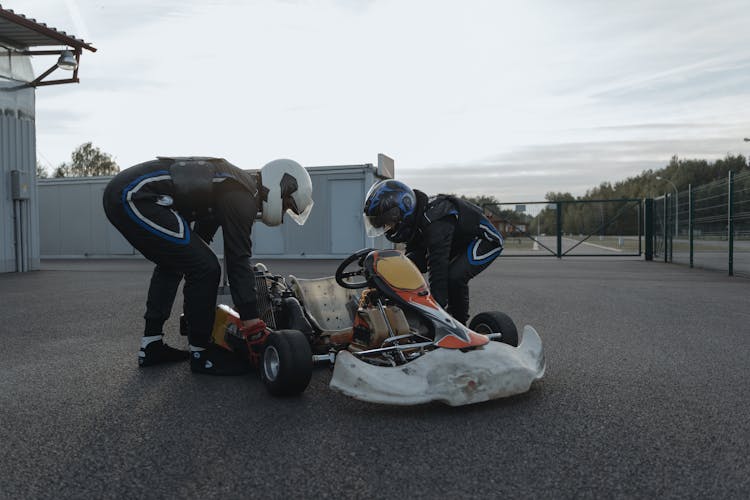 Drivers In Helmets With Kart