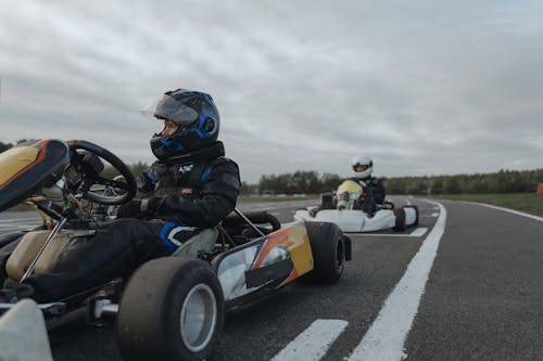 Free Two Men Driving Go Karts In A Circuit Stock Photo