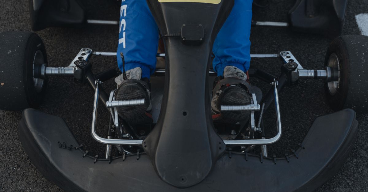 A detailed view of a go-kart's pedals, highlighting the accelerator and brake setup.