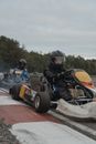 People Driving Go-Karts in Racetrack
