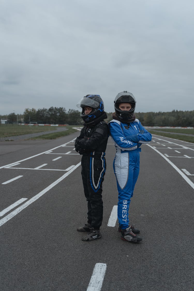 Race Drivers In Racing Suits And Helmets