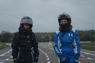 Two Athletes in Racing Suits and Helmets