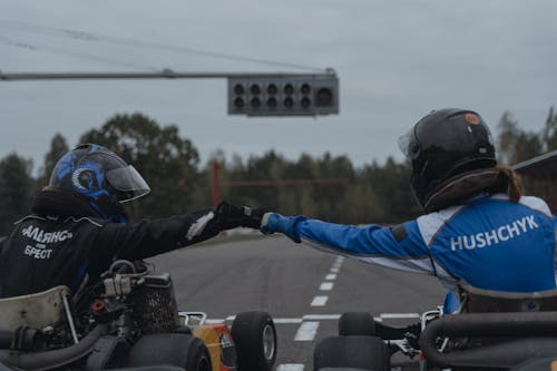 Two Go-Kart Drivers Doing Fist Bump
