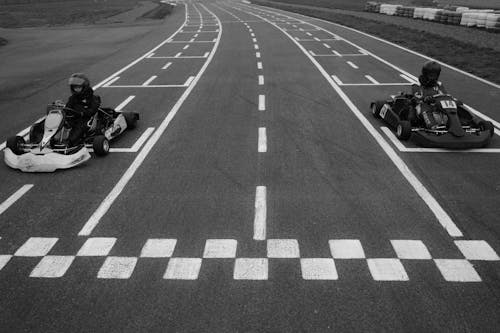 Athletes Driving Go-Karts in Racetrack