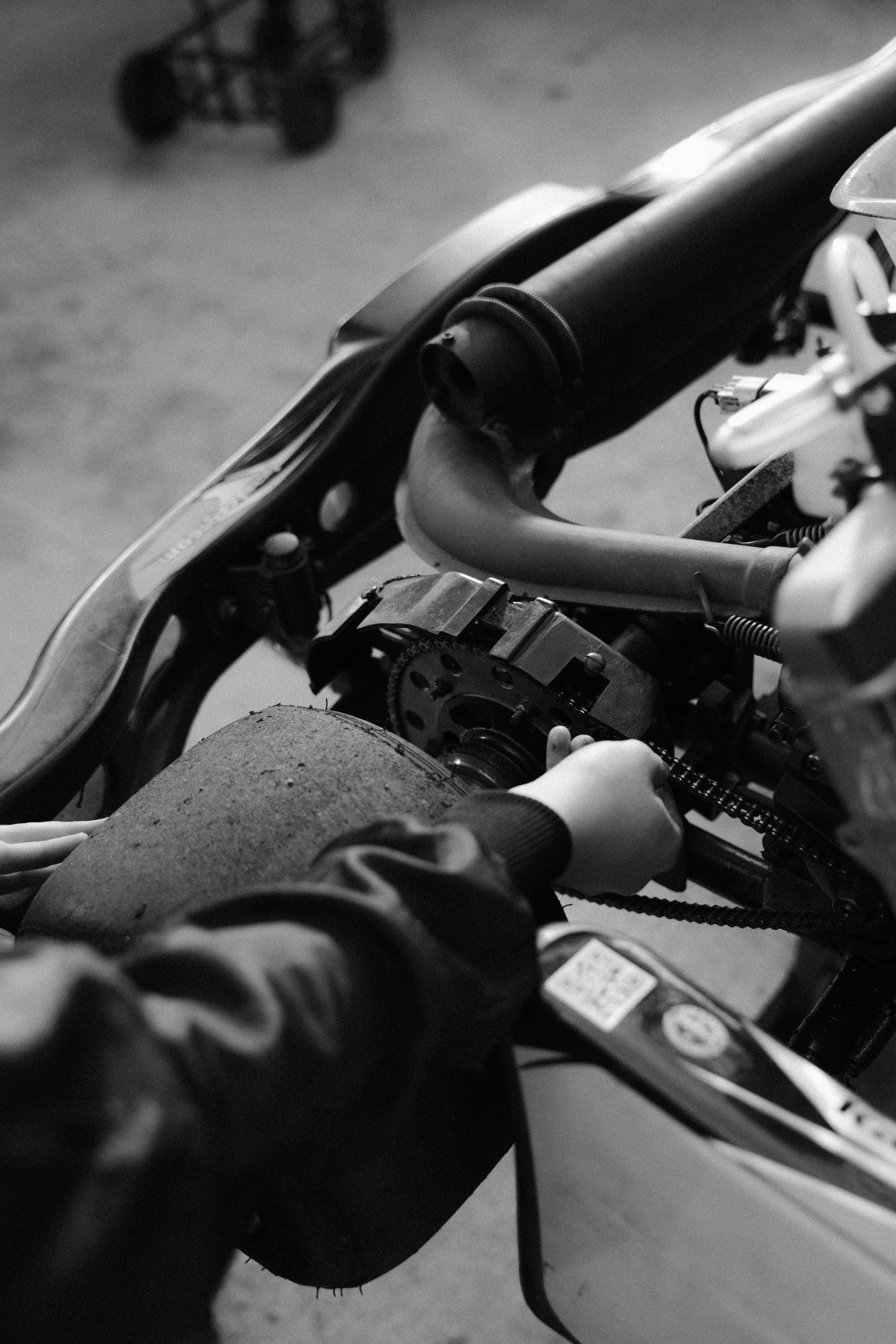 grayscale photo of person riding motorcycle