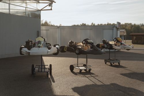 Free Row of go karts parked outdoors in the sunlight, ready for a racing day. Stock Photo