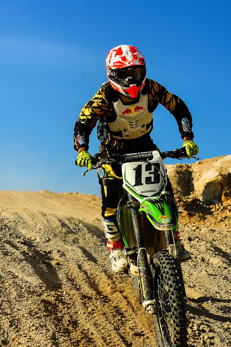 Man Riding Motocross Dirt Bike On Hill