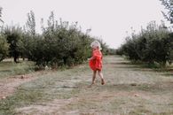 Little girl running on farmland