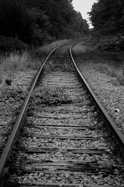 Grayscale Photo of Train Rail