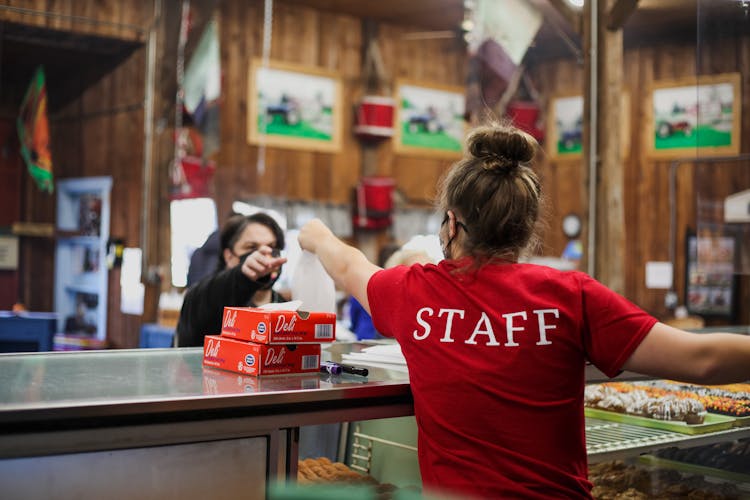 Cashier And Customer In Masks In Cafe