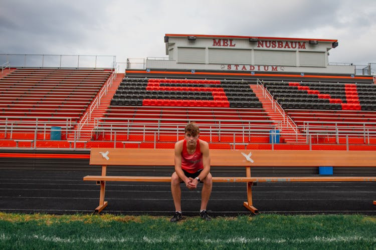 Male Football Player On Bench