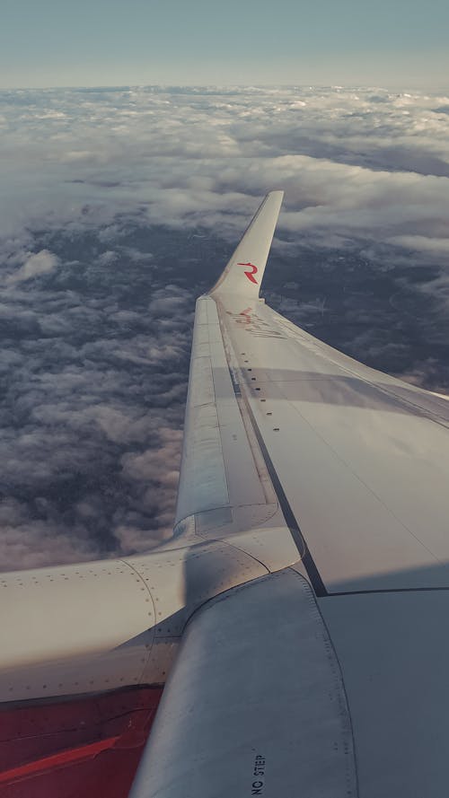 Free Airplane Wing over White Clouds Stock Photo