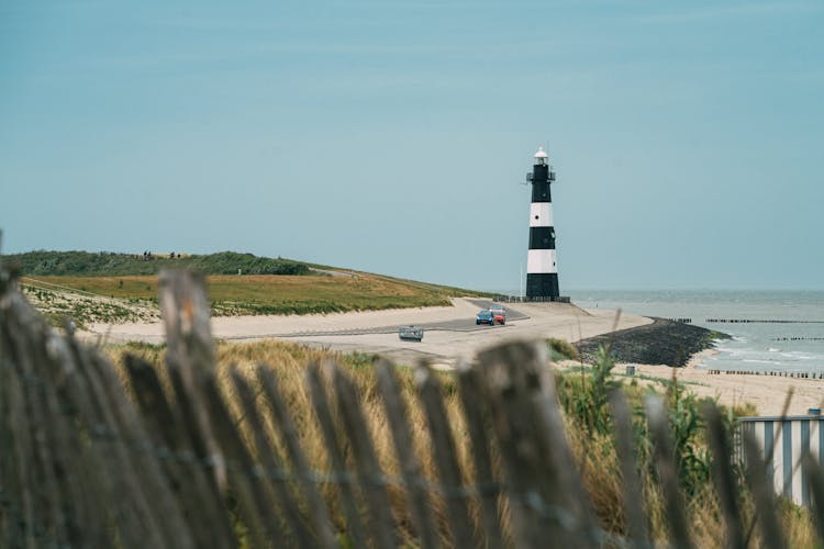 Solitude Lighthouse On Coastline At Sea