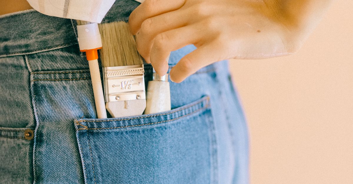Person Holding a Paint Scraper in Her Pocket · Free Stock Photo