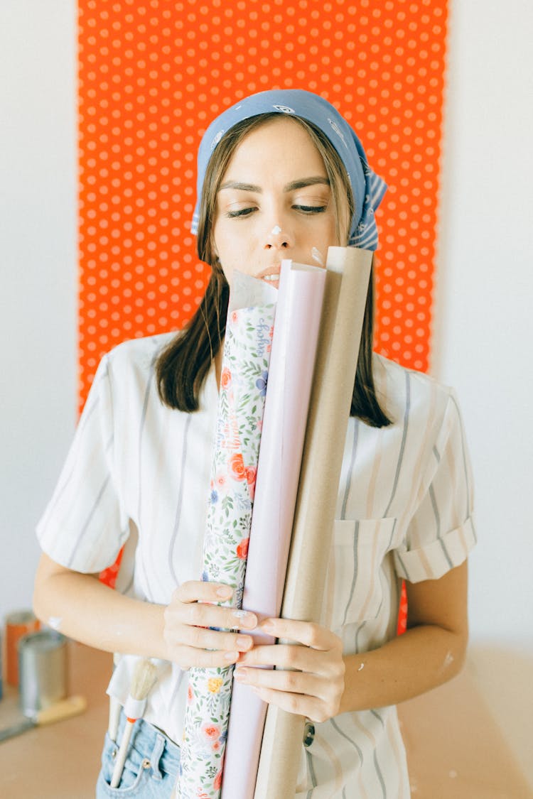 Woman Holding Wallpaper Rolls