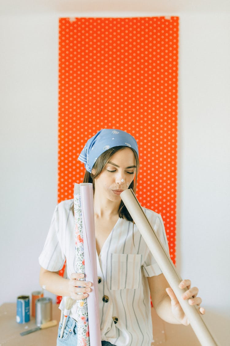 Woman Holding Wallpaper Rolls