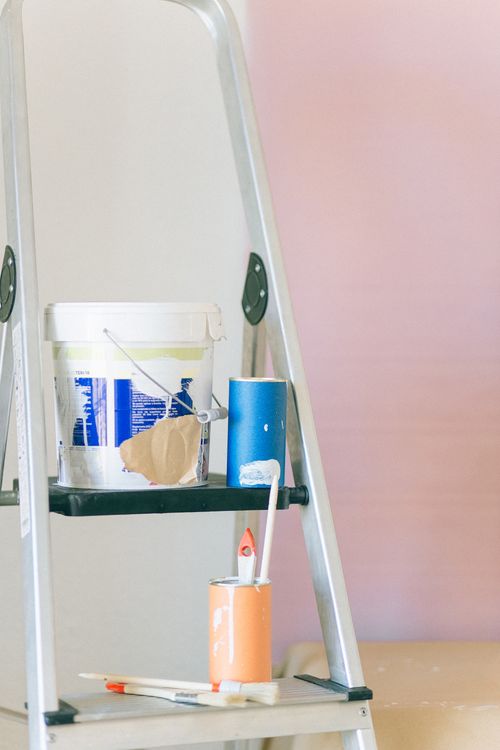 Free A ladder with painting tools and materials used for home renovation and interior design. Stock Photo