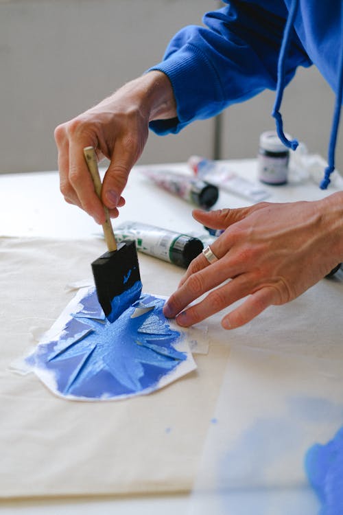 Artist using stencil while drawing in studio