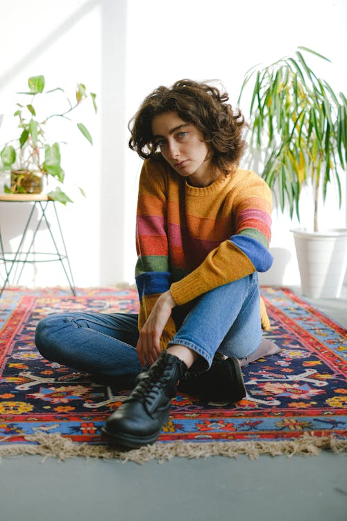 Bored woman sitting in light room on floor