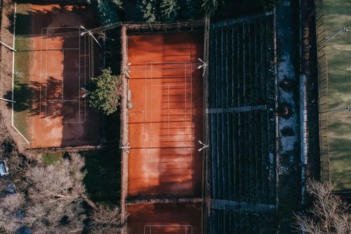 Free Aerial view of modern sports fields with marking and seats for fans under sunlight Stock Photo